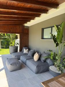 a living room with blue couches at Villa Torrione - Apartments & Pool in Civitanova Marche