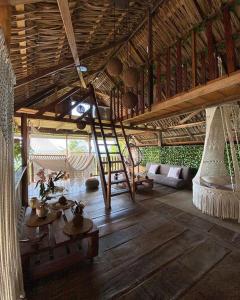 a living room with a wooden ceiling and a table at Bayano Ecolodge in Chepo