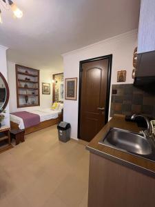 a bathroom with a sink and a bedroom with a bed at Bella's House in Stavros