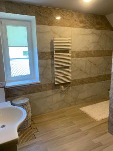 a bathroom with a sink and a window at Green Garden Apartments in Kaunas
