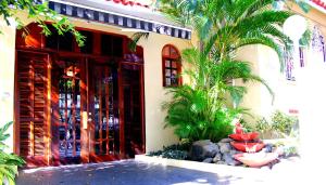 a building with palm trees in front of it at Canario Boutique Hotel in San Juan