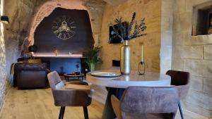 a room with a table and a clock on the wall at Wine Not in Vernou-sur-Brenne