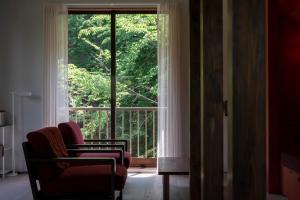 a room with two chairs and a large window at Private Villa 3 minutes from bus stop - in the meantime in Hakone