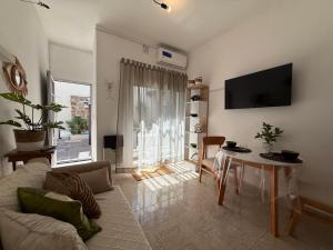 a living room with a couch and a table at VIA VALENTINA "el deseo de volver" departamentos temporales sobre Av Eden centro in La Falda