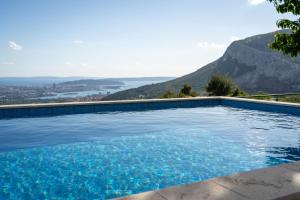 a swimming pool with a view of a mountain at Beverly Klis House in Klis