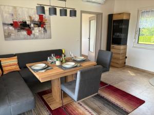 a dining room with a wooden table and chairs at Ferienhaus zum Graben Kohfidisch in Kohfidisch