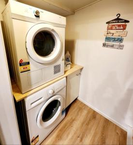 a laundry room with a washer and dryer in it at Million dollar view in Queenstown