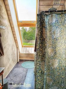 a shower curtain in a room with a window at Villa Sandäng in Löderup +41 photos