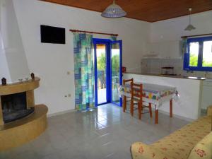 cocina y sala de estar con chimenea y mesa en Tentes Holiday Homes, en Vounaria