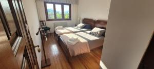a bedroom with two beds and a window at Casa Luisín Jacuzzi exterior Casa completa 10 personas in El Pino