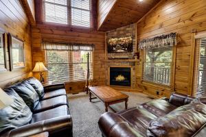 a living room with a couch and a fireplace at Mountain Treasure by Venture Smoky Mountains in Sevierville