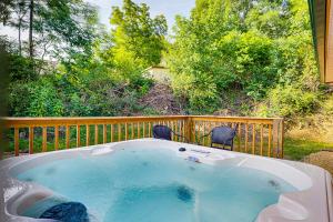 a hot tub on a deck with two chairs at Mountain View by Venture Smoky Mountains in Pigeon Forge +10 photos