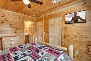 a bedroom with a bed in a log cabin at Mountain View by Venture Smoky Mountains in Pigeon Forge