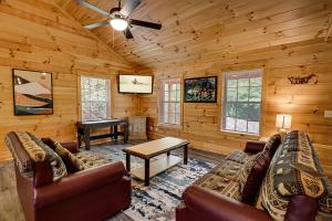 a living room with a couch and a table in a cabin at Mountain View by Venture Smoky Mountains in Pigeon Forge