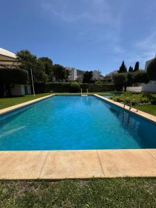 a large blue swimming pool in a yard at Albir Adventino LOVE in Albir