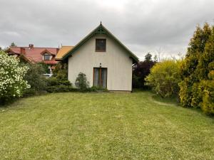 a house with a large yard in front of it at Villa Wejsunka in Wejsuny