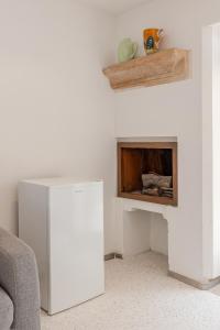a living room with a white fireplace and a couch at Residence Court of the Seminary in Otranto