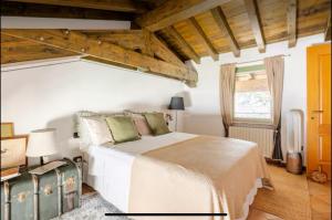 a bedroom with a white bed and a window at Casa Frida, penthouse on the lake in Lonato del Garda