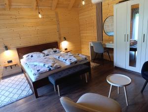 a bedroom with a bed in a wooden room at Wooden Villa Old Oak Plitvice Lakes in Seliste Dreznicko