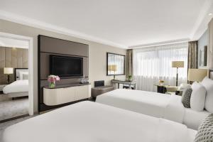 A bed or beds in a room at Kempinski Hotel Corvinus Budapest