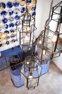 a group of chandeliers with blue and white vases on a wall at Luxury Home + 20 amenidades in San Miguel de Allende +46 photos