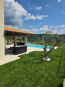 a villa with a pool and a tree in a yard at Villa Eva Marezige Heated Saltwater Pool near Koper in Marezige