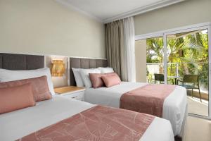 Postel nebo postele na pokoji v ubytování Wyndham Alltra Punta Cana All Inclusive Resort