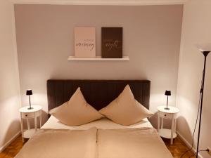 a bedroom with a bed with three pillows on it at Ferienwohnung De Lorenzi in Boppard
