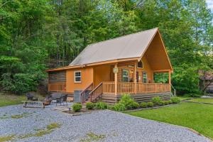 a large wooden cabin with a porch and a deck at The Hideaway at Grassy Branch by Venture Smoky Mountains in Sevierville