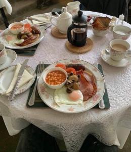 a table with a plate of breakfast food on it at Whortleberry Studio B & B in Porlock +11 photos