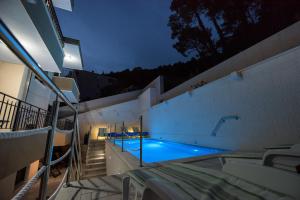 a swimming pool in a house at night at Villa Tomislav 2 in Brela