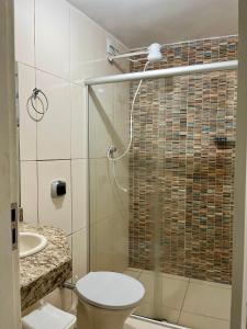 a bathroom with a shower with a toilet and a sink at Casa Zara in Diamantina
