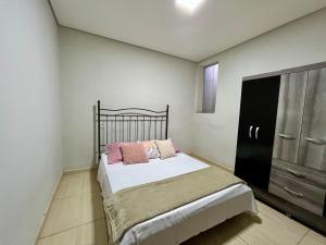 - une chambre avec un lit et une armoire noire dans l'établissement Casa Zara, à Diamantina