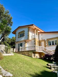 a large house with a balcony on a lawn at Villa Josefi en Isla 5816 in Isla