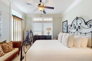 a bedroom with a bed and a ceiling fan at Cottage House #201 in Corpus Christi +17 photos