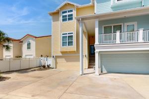 a house with a garage and a fence at Cottage House #201 in Corpus Christi
