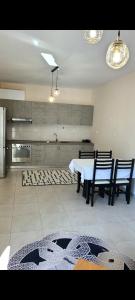 a kitchen with a table and chairs in a room at Marinela Apartment 2 in Tirana