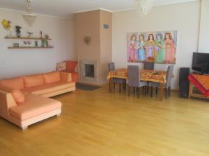 a living room with a couch and a table at Viva B&B in Anavyssos