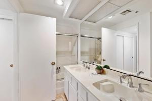 a white bathroom with two sinks and a mirror at Esprit Escape in Palm Springs +7 photos