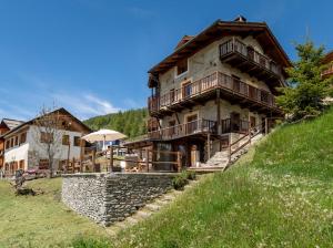 a large building on the side of a hill at chalet Sestriere in Champlas du Col