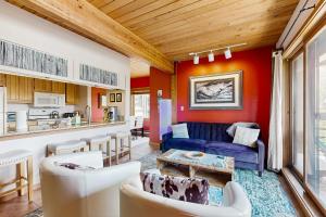 a living room with red walls and a blue couch at Blue Sky Porch in Crested Butte
