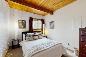 a bedroom with a large bed and a wooden ceiling at Blue Sky Porch in Crested Butte