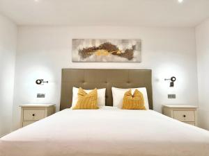 a bedroom with a large white bed with yellow pillows at Estrella Del Sur Tauro Ocean Wiew Heated Pool in Mogán +72 photos