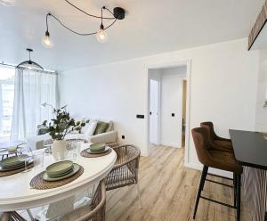 a white living room with a white table and chairs at Brisa atlántica in Portonovo