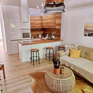 a living room with a couch and a kitchen at Baltic Nature in Łukęcin