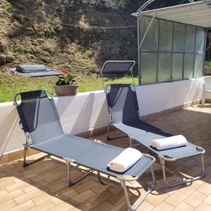 two chairs and a table on a patio at Casa Eliana Mountain Lake Iseo Hospitality in Sovere