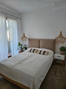 a bedroom with a large bed and a window at Baltic Nature in Łukęcin +18 photos
