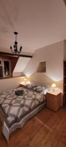 a bedroom with a large bed and two lamps at Maison de caractère - L'évasion forestière in Baguer-Pican