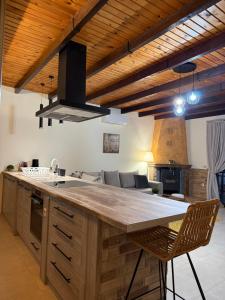 a kitchen with a large wooden island in a room at Paris Apartment in Néa Khilí