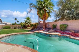 a swimming pool in a yard with palm trees at Avondale Abode in Avondale